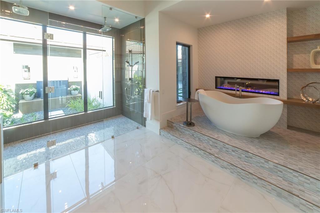 18 Caribbean Road Naples, FL 34108 - Photo 27 of 45 Bathing sanctuary with a free-standing tub and fireplace
