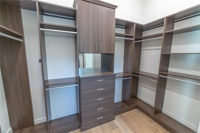 a view of walk in closet with empty racks