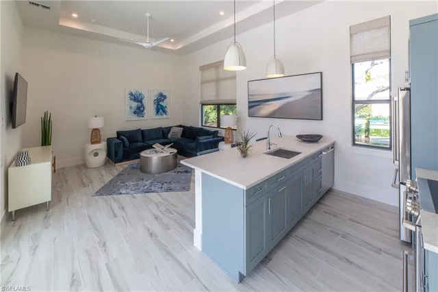 a kitchen with a sink cabinets and wooden floor