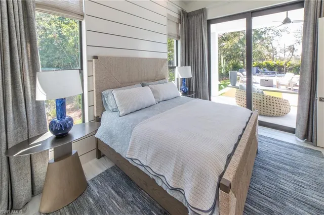 a bedroom with a bed and a large window