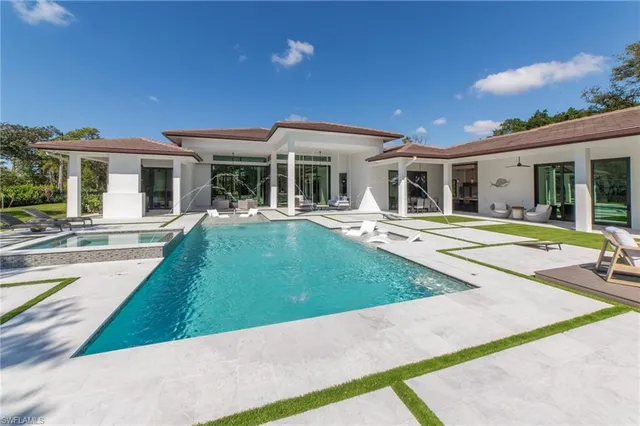 a view of a house with sitting area and garden