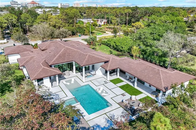 an aerial view of a house with garden space and street view
