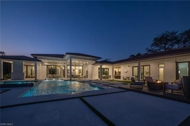 a living room with furniture pool table and a large window