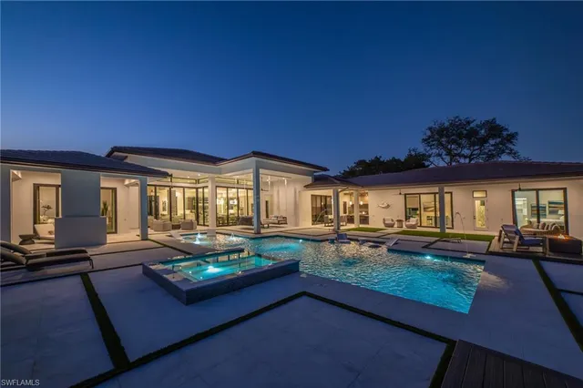 a living room with fireplace furniture and a large window