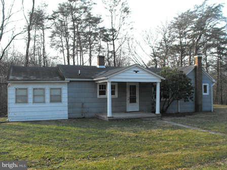 116 Paw Paw Road North Bloomery, WV 26817 - Photo 1 of 16 a front view of a house with a garden