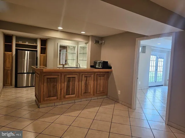 a kitchen with stainless steel appliances a sink and a refrigerator