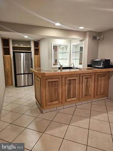 a large kitchen with stainless steel appliances lots of counter top space