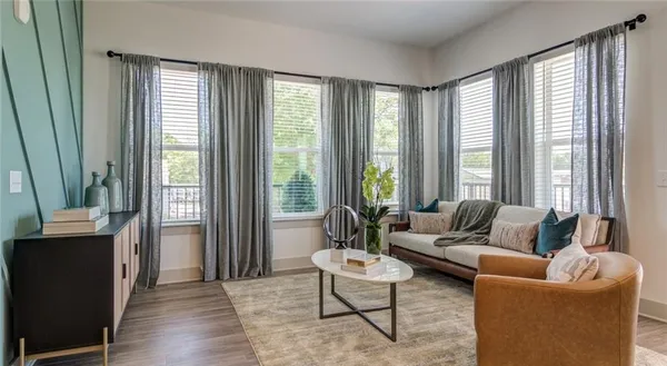 a living room with furniture and a large window