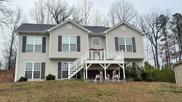 a front view of a house with large windows