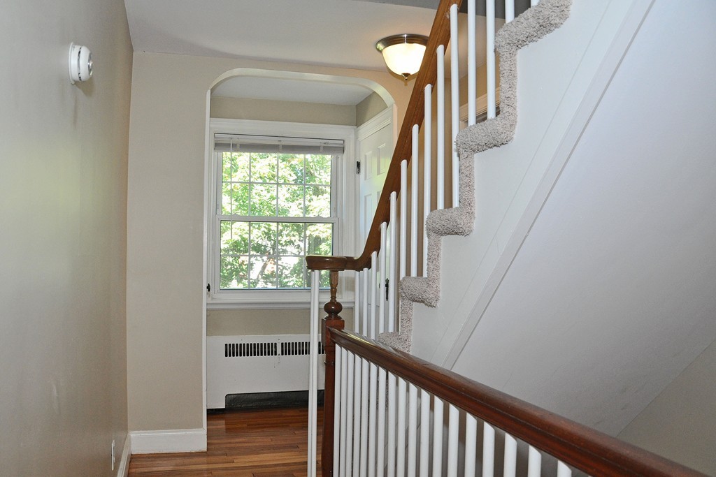 90 Martin Road Milton, MA 02186 - Photo 13 of 17 a view of hallway with wooden floor and stairs