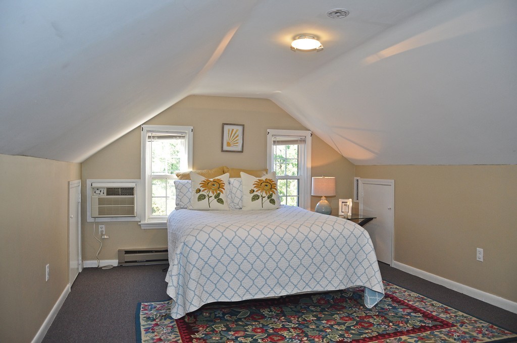 90 Martin Road Milton, MA 02186 - Photo 14 of 17 a bedroom with a bed and dresser with mirror