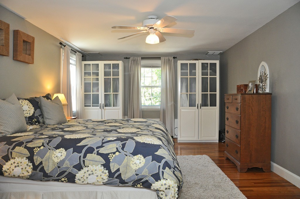 90 Martin Road Milton, MA 02186 - Photo 10 of 17 a bedroom with a bed and wooden floor