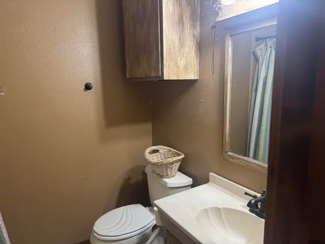 a white toilet sitting next to a bathroom sink