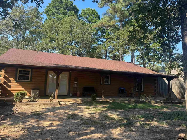 a view of a house with a yard and plants