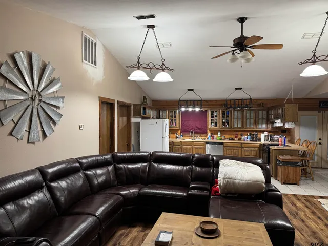 a living room with furniture and a chandelier