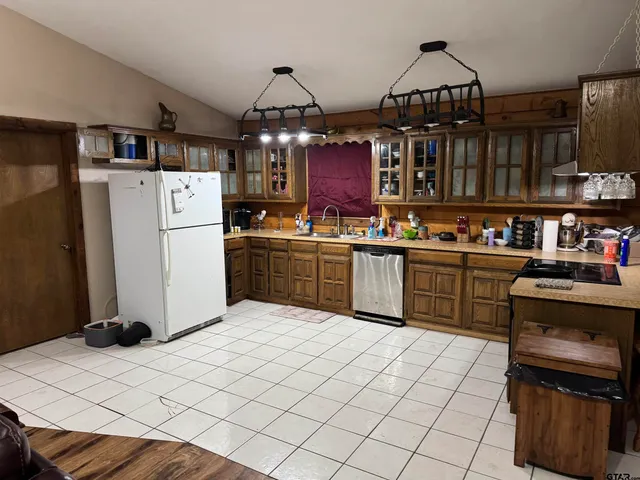a living room with furniture a baby crib and a wooden floor