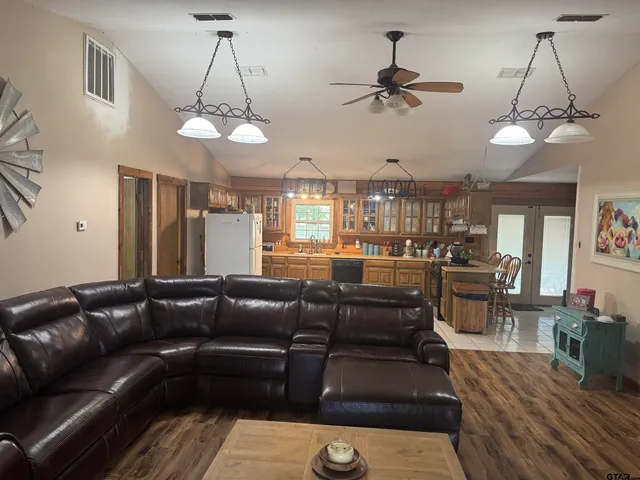 a living room with lots of furniture and a chandelier