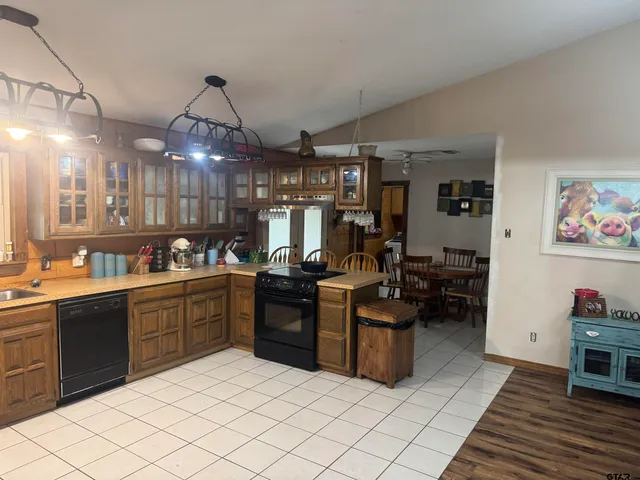 a kitchen with cabinets and chairs