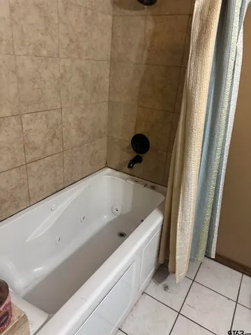 a bathroom with a bathtub and shower