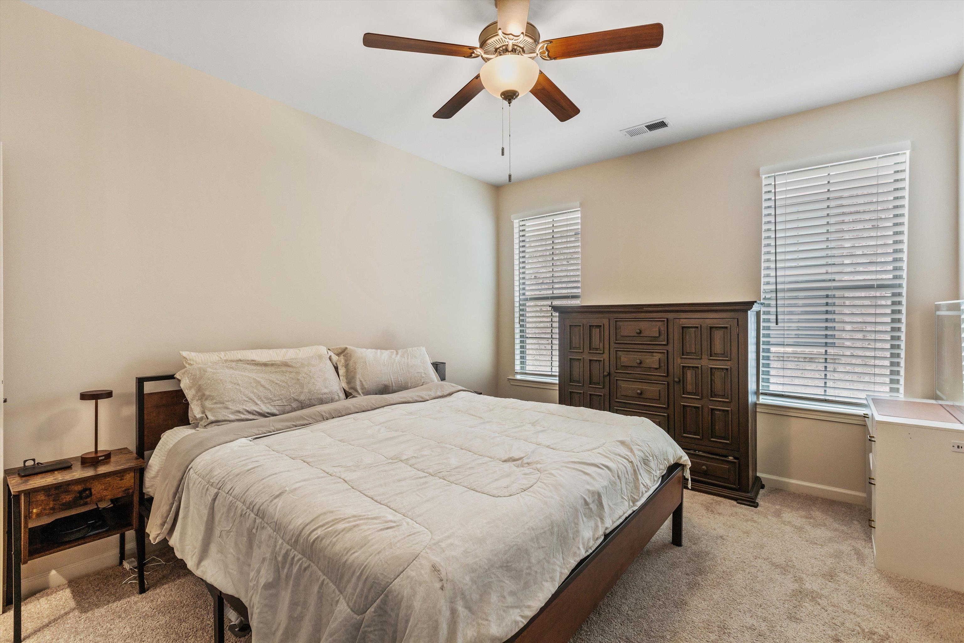 10139 Macon Road Cordova, TN 38018 - Photo 13 of 31 Carpeted room featuring a ceiling fan with integrated lighting, two windows with blinds, and light-toned walls