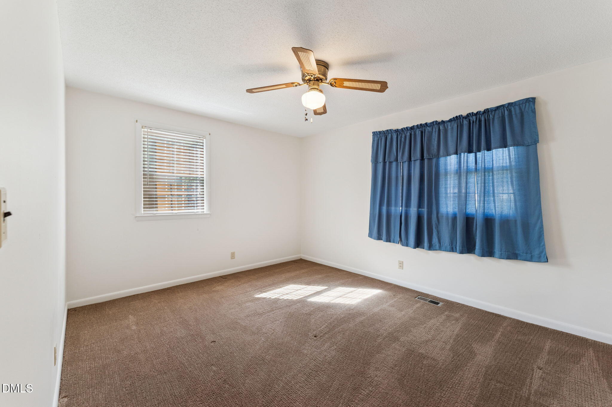149 Fairview Village Road Dunn, NC 28334 - Photo 11 of 22 an empty room with windows and fan