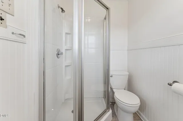a white toilet sitting next to a bathroom sink