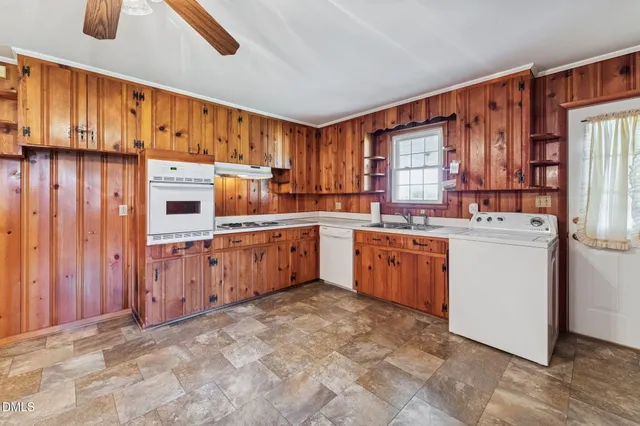 a kitchen with a sink counter top space cabinets and stainless steel appliances