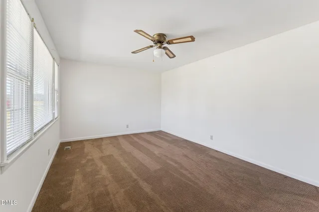 a view of a room with a window and a ceiling fan