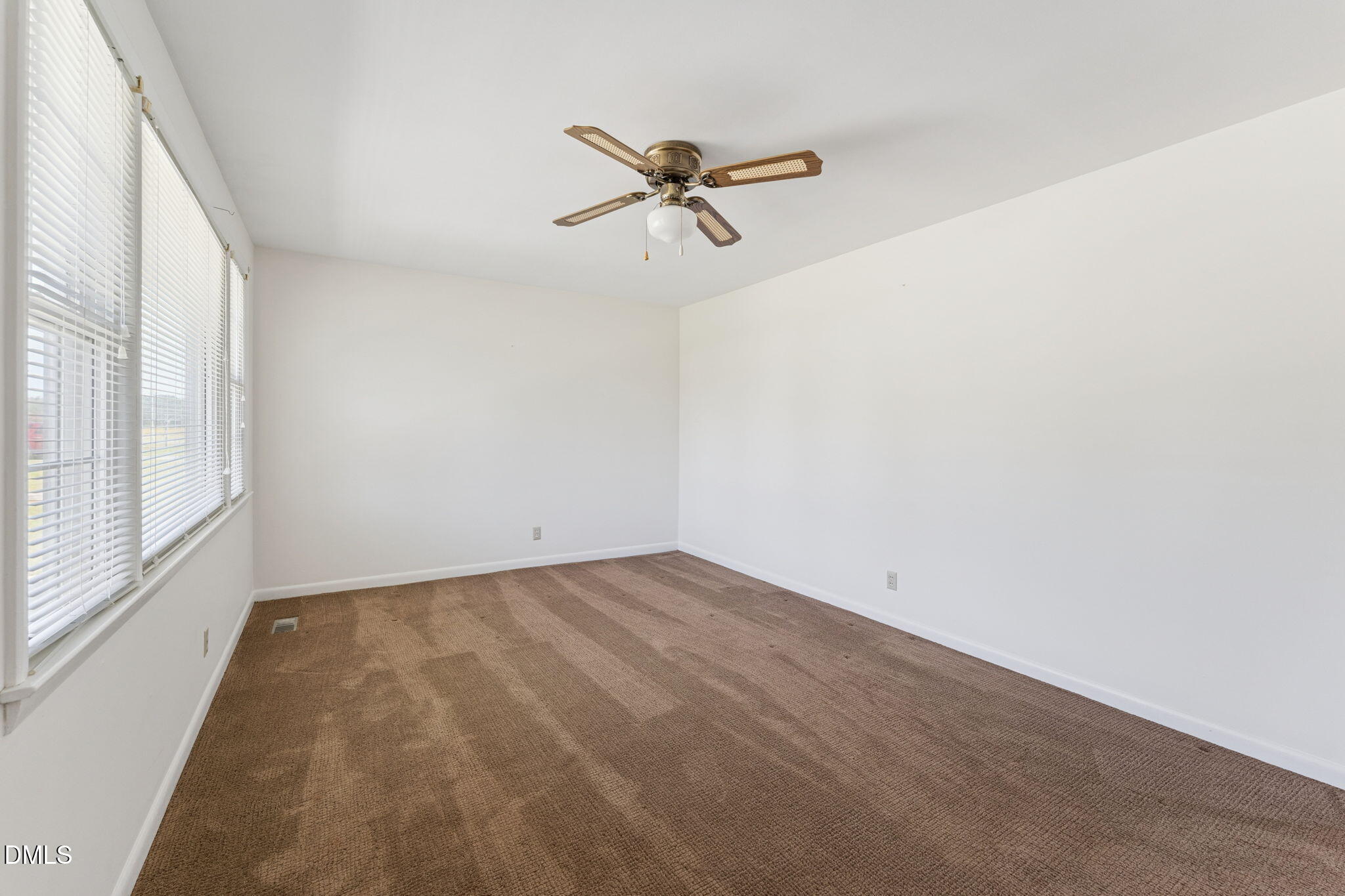 149 Fairview Village Road Dunn, NC 28334 - Photo 7 of 22 a view of a room with a window and a ceiling fan