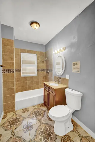 a bathroom with a granite countertop toilet a sink and a mirror