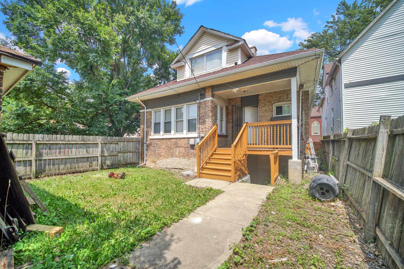 1 East 114th Street Chicago, IL 60628 - Photo 24 of 25 a front view of a house with a garden and plants