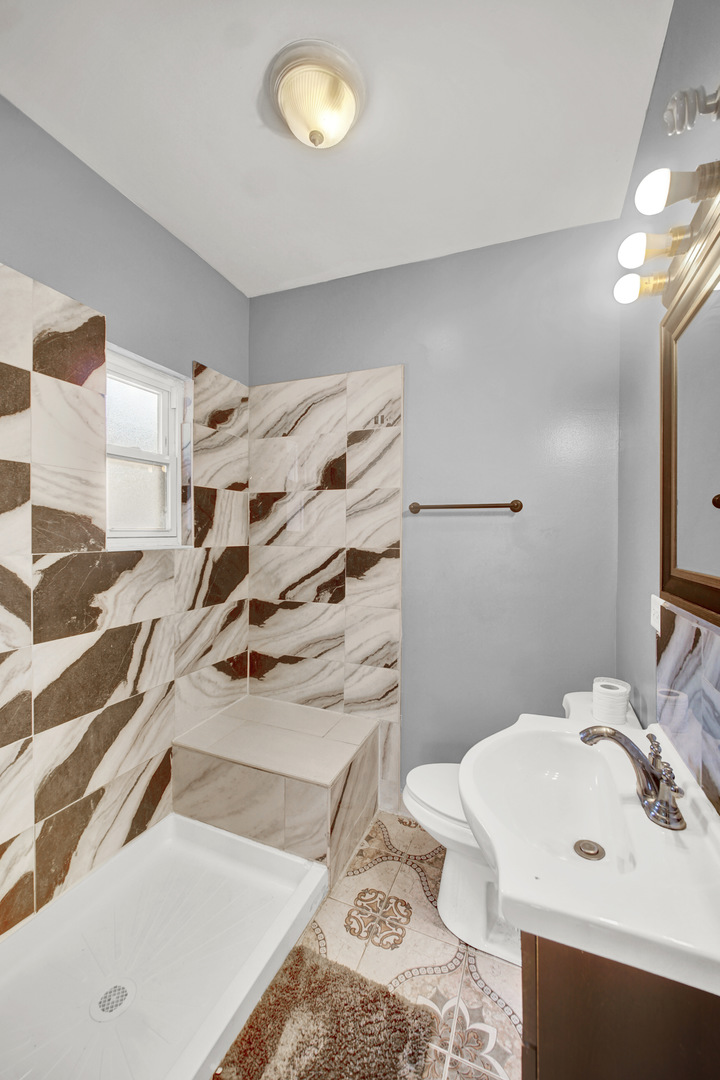 1 East 114th Street Chicago, IL 60628 - Photo 3 of 25 a bathroom with a sink toilet and shower