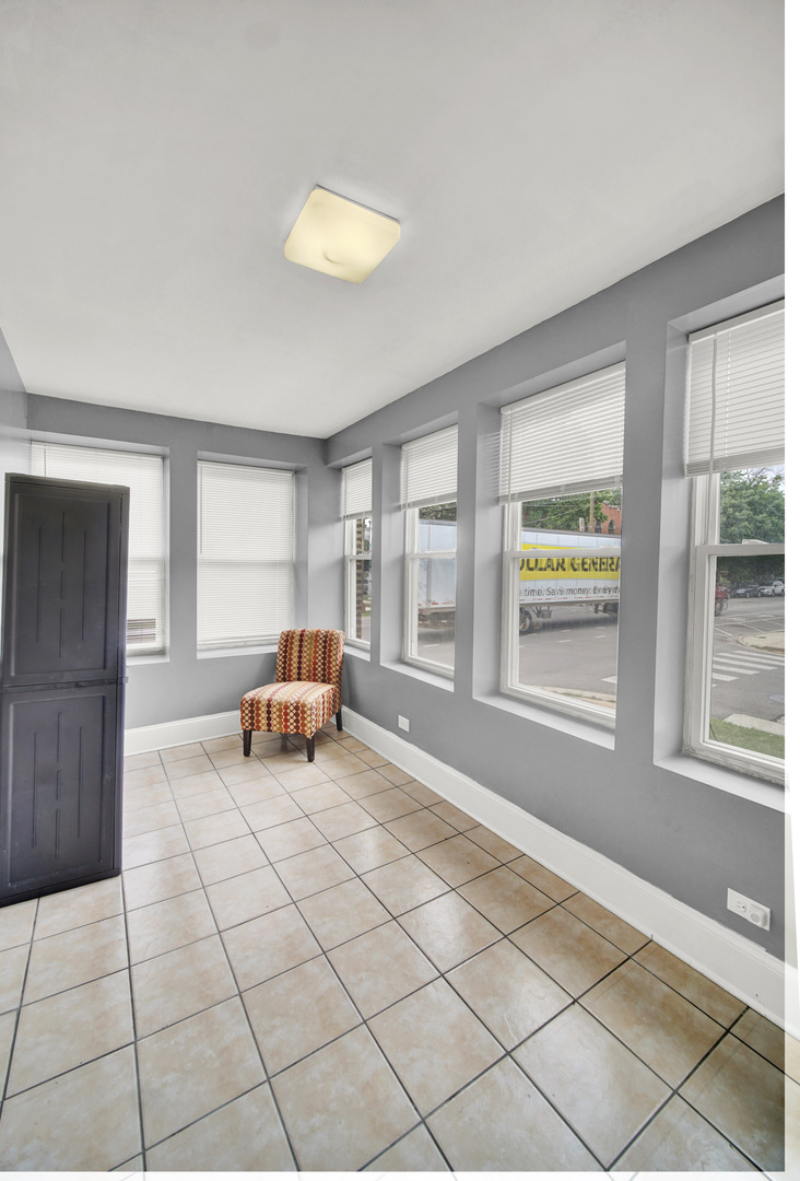 1 East 114th Street Chicago, IL 60628 - Photo 6 of 25 a living room with furniture and a window
