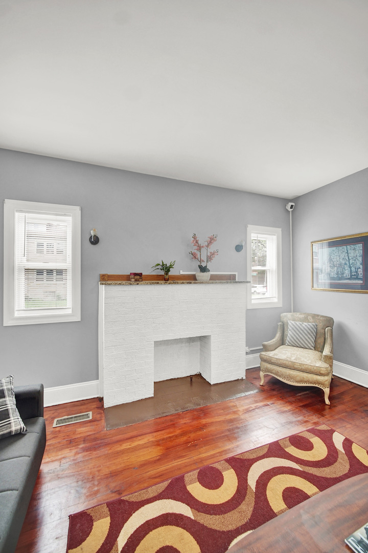 1 East 114th Street Chicago, IL 60628 - Photo 7 of 25 a living room with furniture and a fireplace
