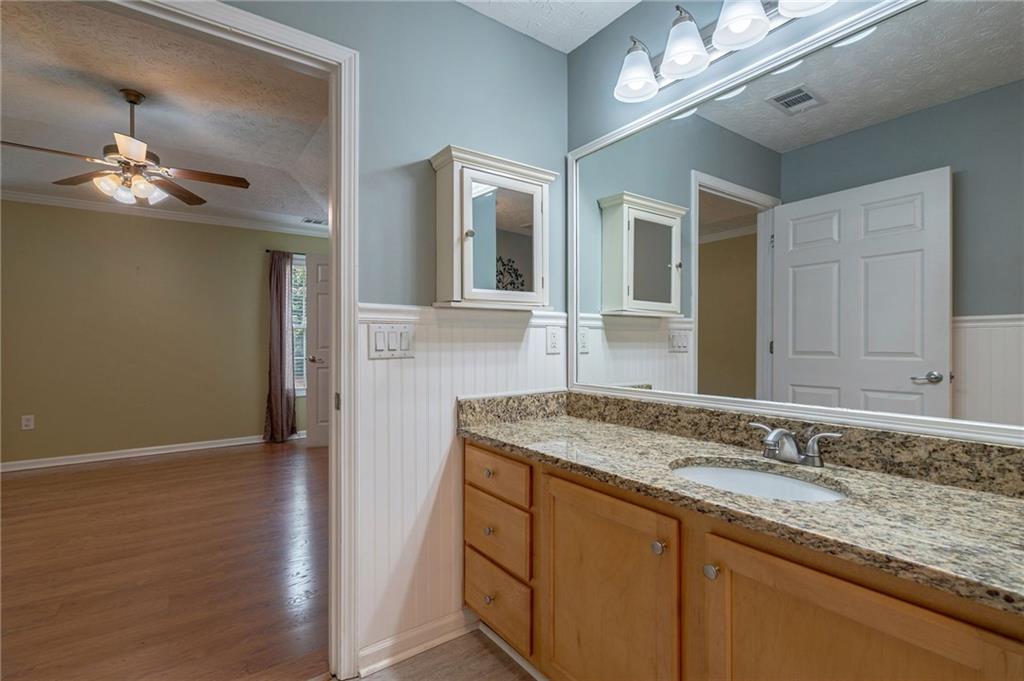 245 Memory Lane Winder, GA 30680 - Photo 29 of 62 a bathroom with a granite countertop sink and a mirror