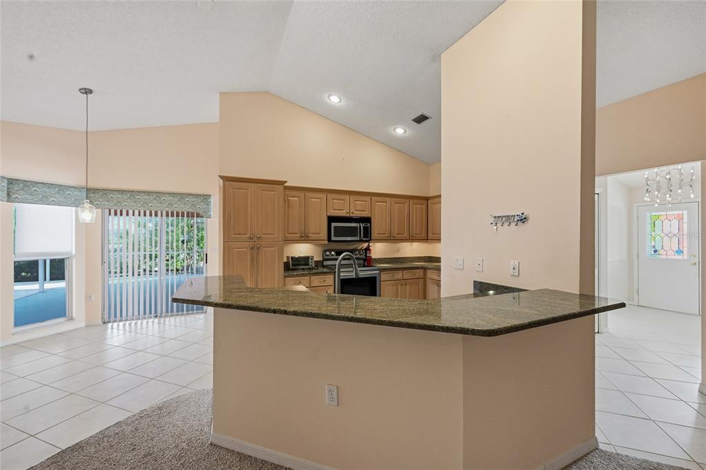 3732 Surrey Lane Sarasota, FL 34235 - Photo 15 of 35 a kitchen with kitchen island a sink appliances and windows