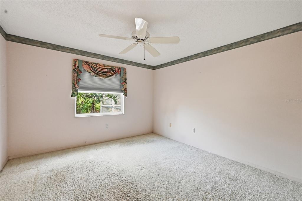 3732 Surrey Lane Sarasota, FL 34235 - Photo 19 of 35 an empty room with windows and fan
