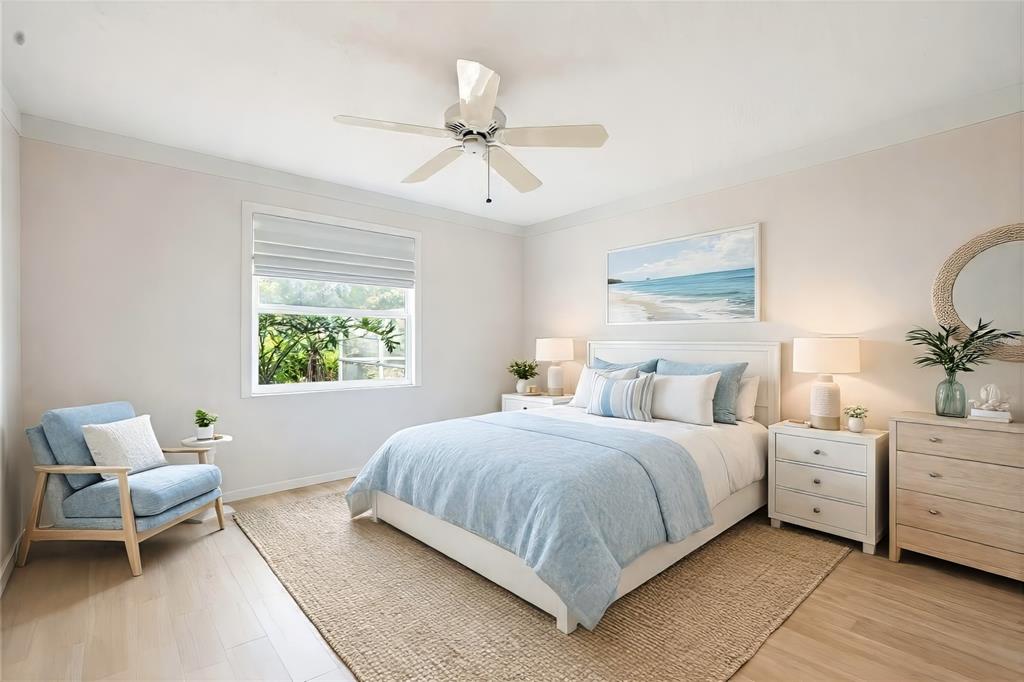 3732 Surrey Lane Sarasota, FL 34235 - Photo 20 of 35 a bedroom with a bed and a chandelier