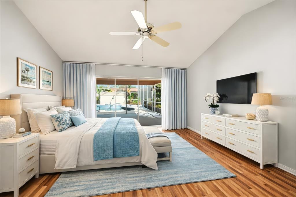 3732 Surrey Lane Sarasota, FL 34235 - Photo 25 of 35 a bedroom with a large bed and a flat screen tv