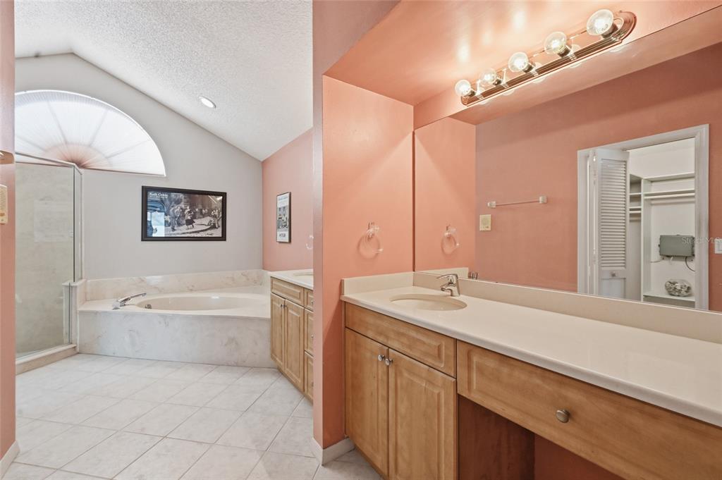 3732 Surrey Lane Sarasota, FL 34235 - Photo 27 of 35 a bathroom with a tub sink and mirror