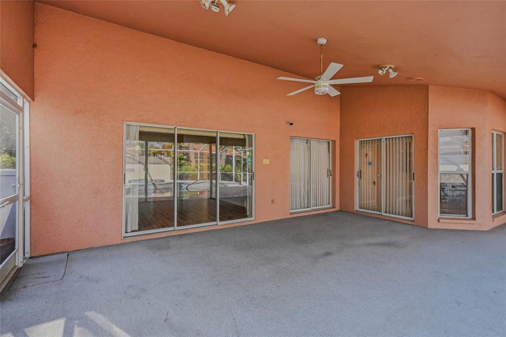 3732 Surrey Lane Sarasota, FL 34235 - Photo 30 of 35 an empty room with chandelier fan and windows