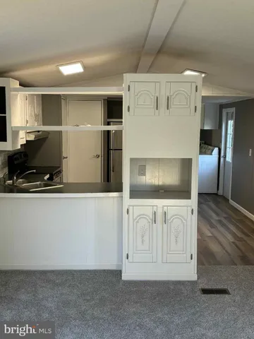 a metallic refrigerator freezer sitting in a kitchen
