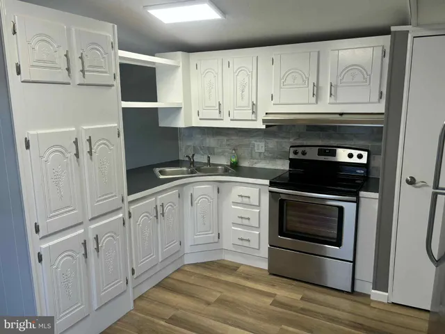 a room with wooden floor and staircase