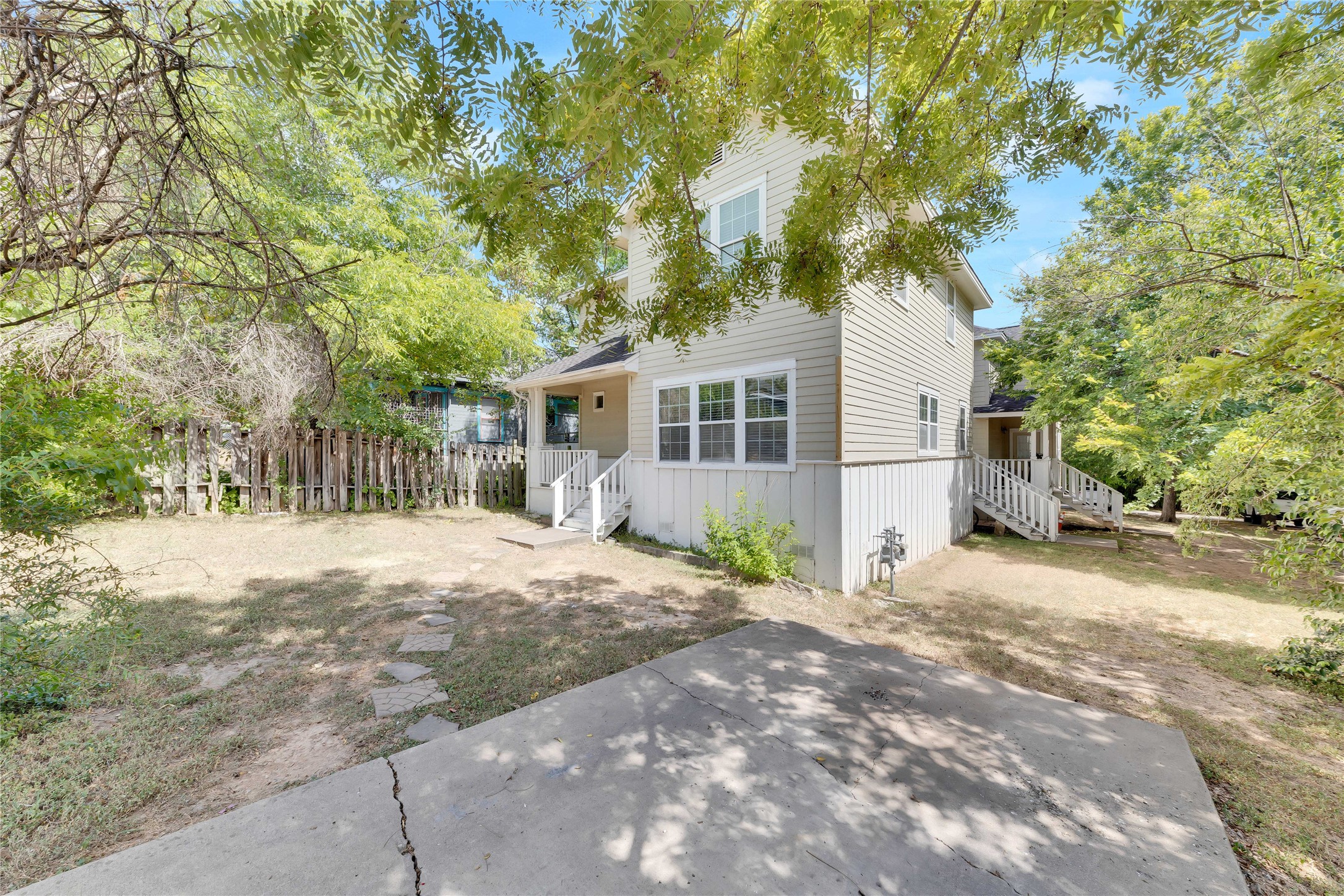 2201 East 18th Street, Unit B Austin, TX 78702 - Photo 24 of 25 A welcoming home with a spacious yard and ample potential, nestled under a canopy of mature trees.