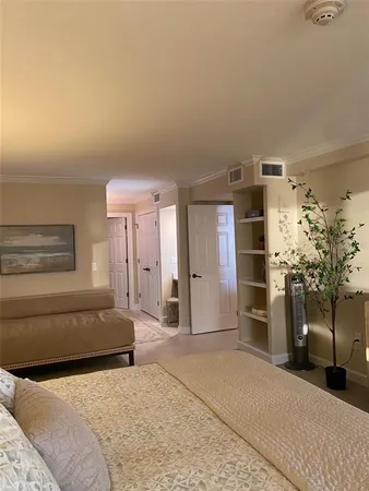 a bedroom with a bed and a couch