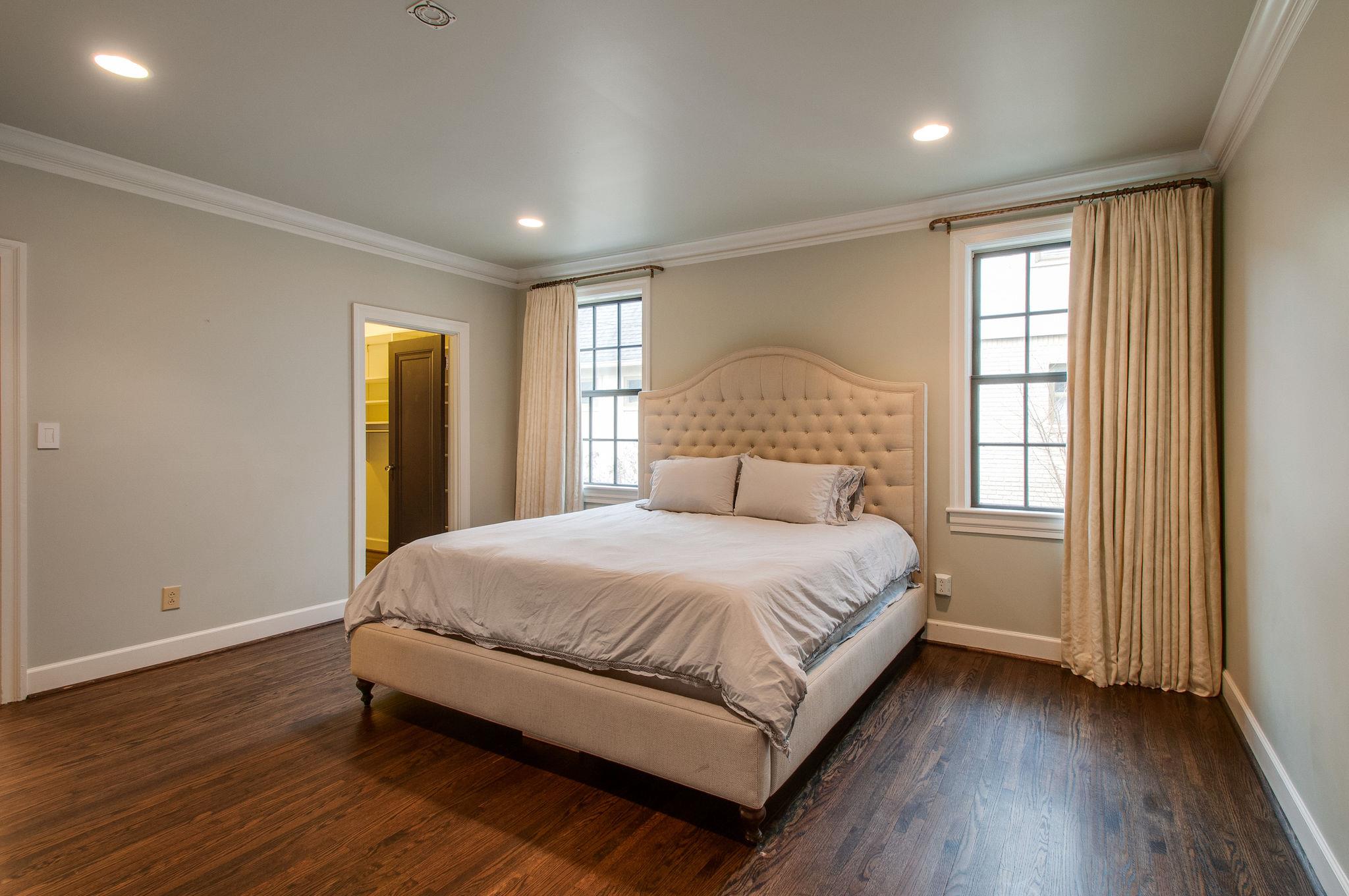 232 Cherokee Road Nashville, TN 37205 - Photo 12 of 24 a large bedroom with a bed and wooden floor