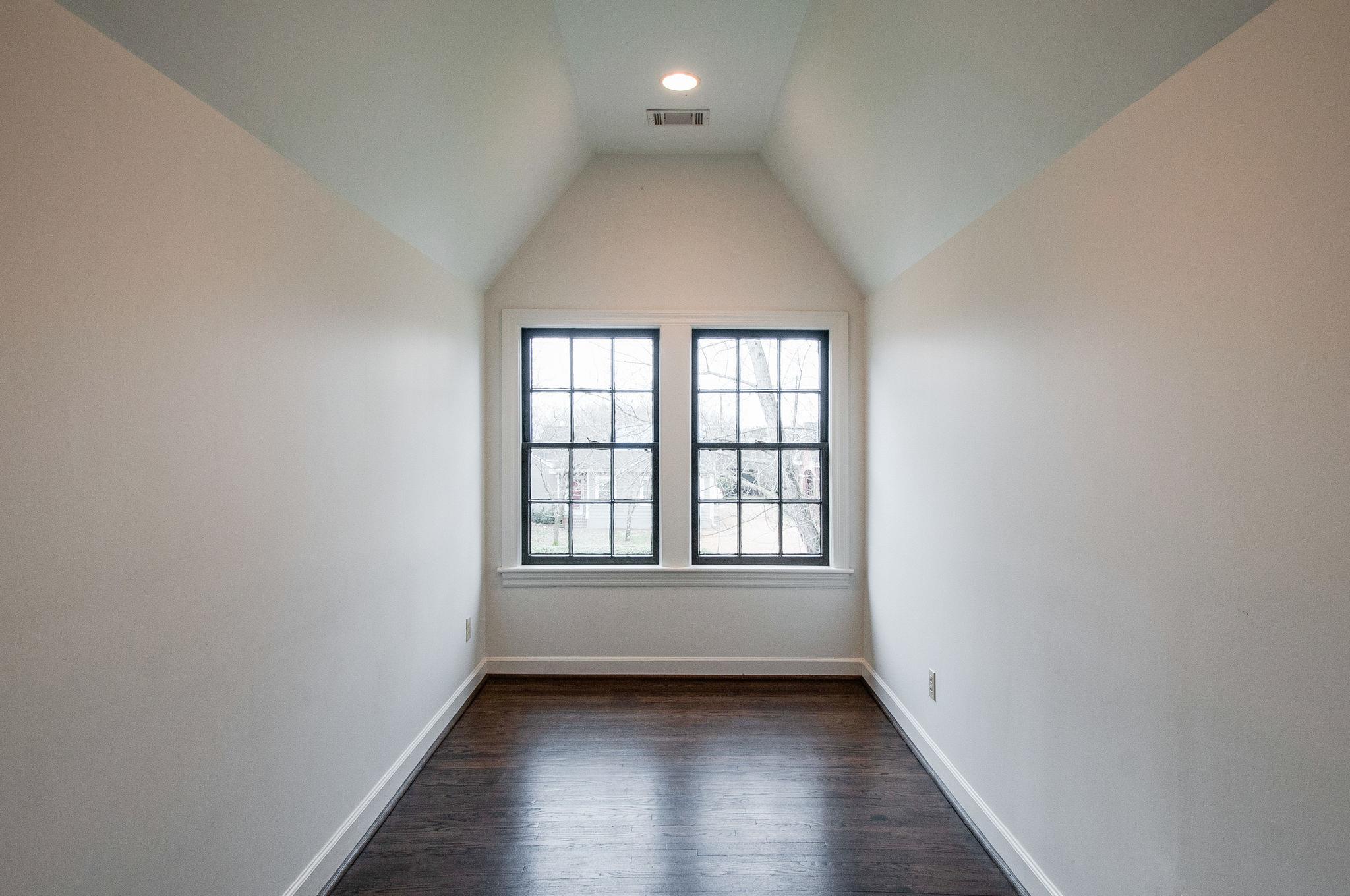 232 Cherokee Road Nashville, TN 37205 - Photo 16 of 24 an empty room with wooden floor and windows