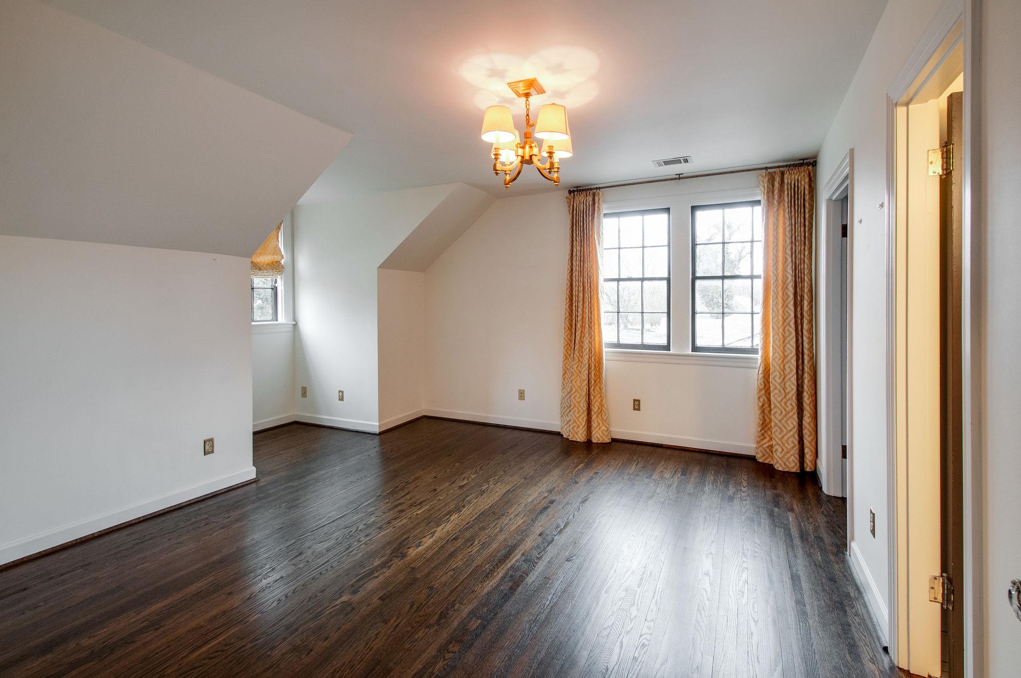 232 Cherokee Road Nashville, TN 37205 - Photo 17 of 24 an empty room with wooden floor chandelier and windows