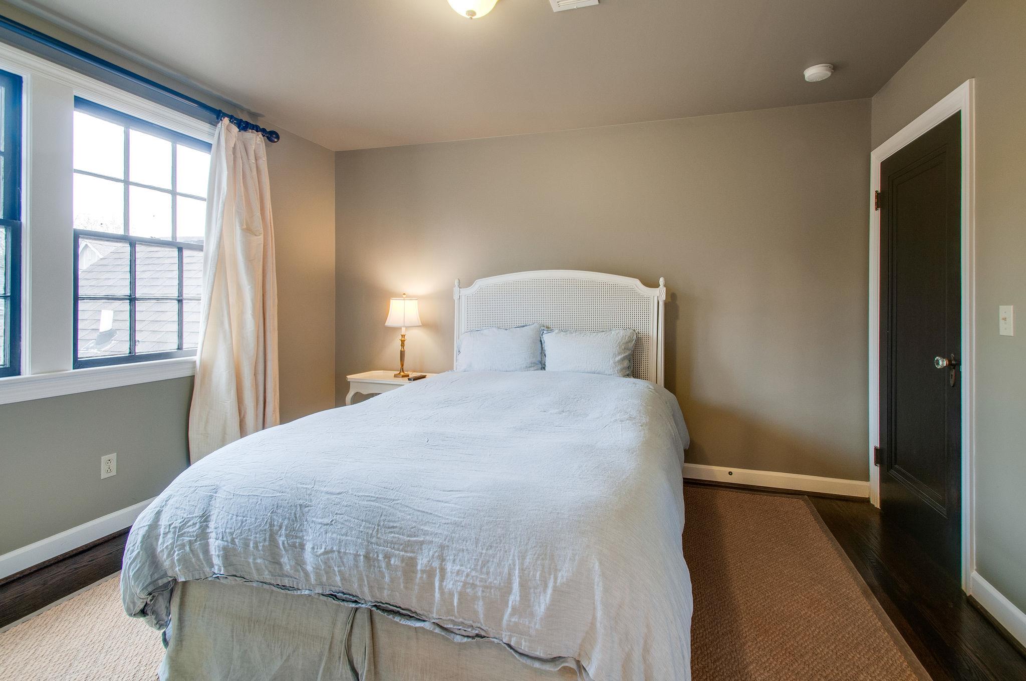 232 Cherokee Road Nashville, TN 37205 - Photo 19 of 24 a bedroom with a bed and window