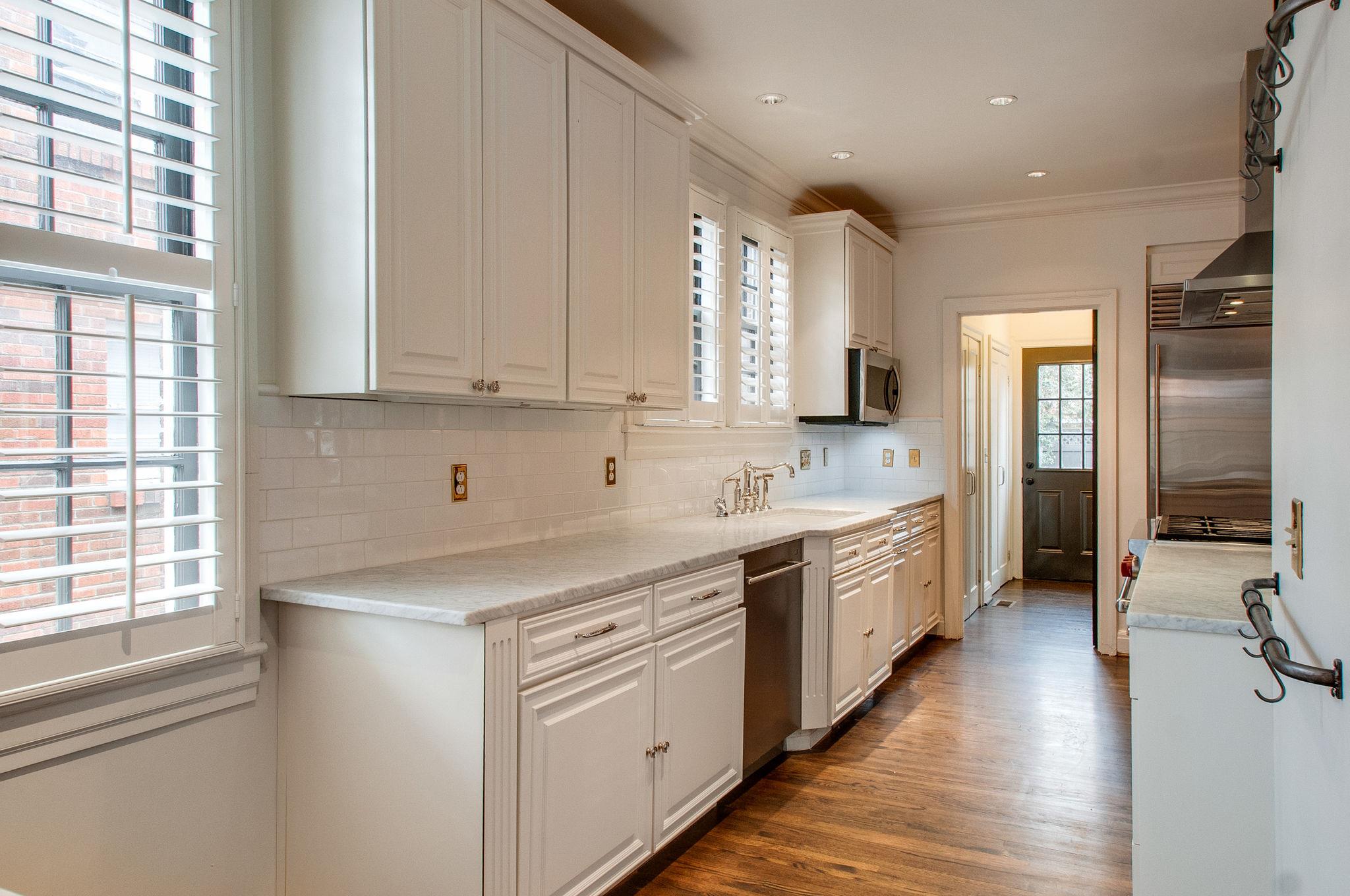 232 Cherokee Road Nashville, TN 37205 - Photo 6 of 24 a view of a kitchen counter space a sink and windows